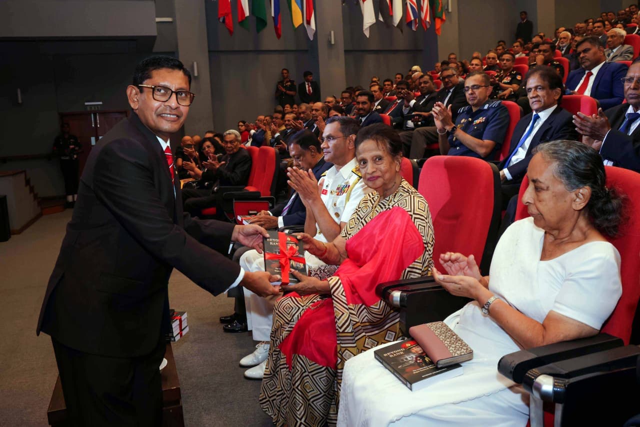 Major General (Retd) Milinda Peiris presenting a copy of Beyond Rank to Mrs Ranjini Perera, wife of the late General Deshamanya Denis Perera, founder of KDU.